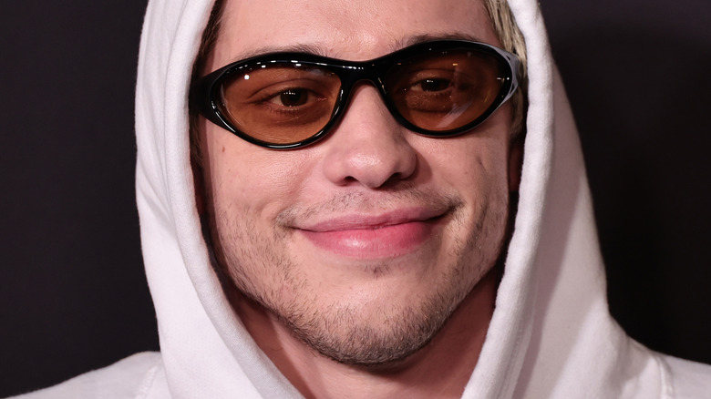 Pete Davidson wearing black shades