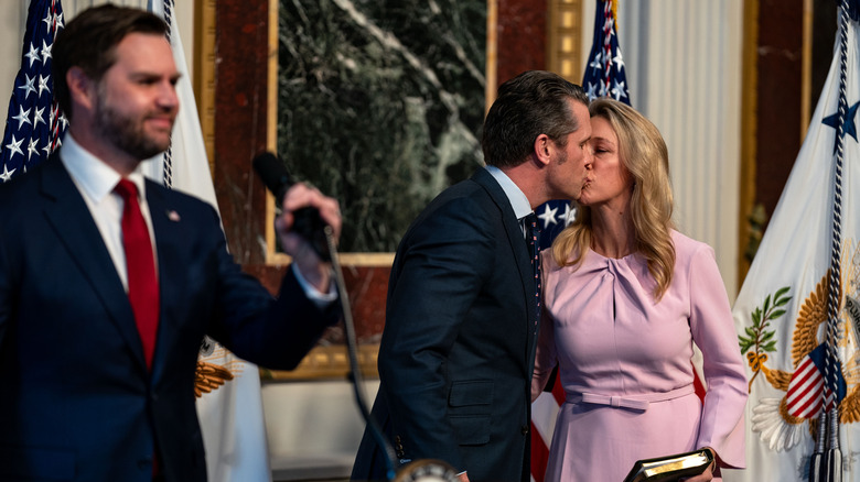 Pete and Jennifer Hegseth kiss after his swearing-in ceremony, while JD Vance smiles at the audience