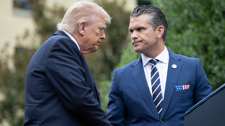 Donald Trump and Pete Hegseth shaking hands.