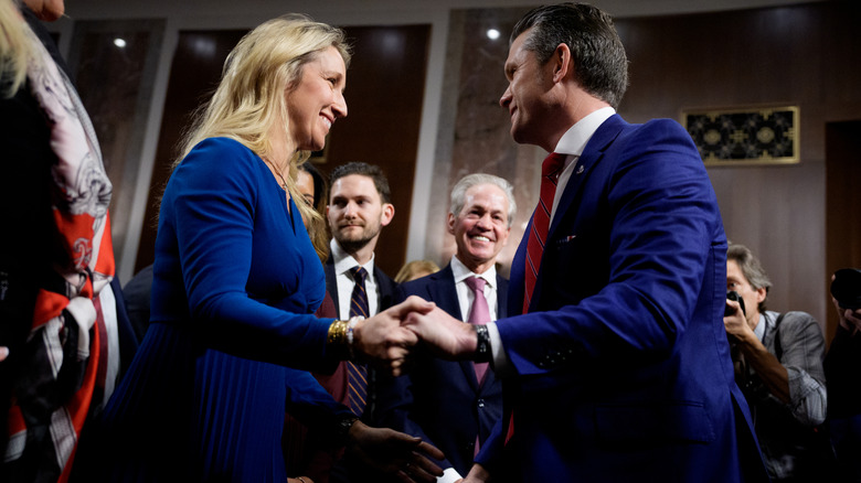Jennifer and Pete Hegseth holding hands at his confirmation hearing.