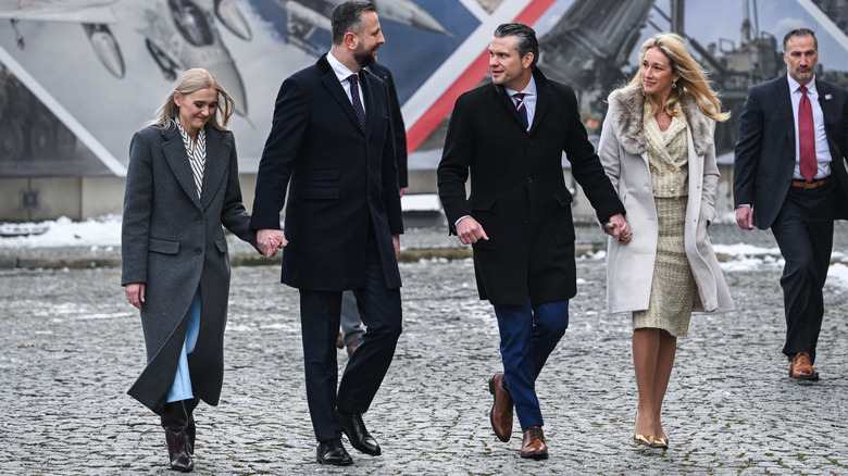 The Hegseths walking alongside the Police Secretary of Defense and his wife.