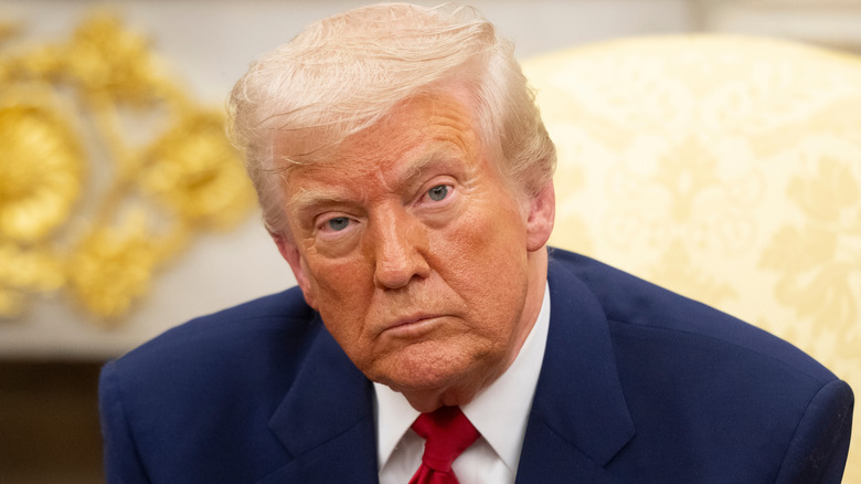 Donald Trump looking solemn in the Oval Office