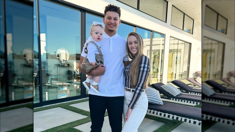 Patrick and Brittany Mahomes posing with daughter Sterling
