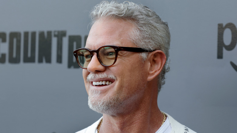 Eric Dane smiles for photographers on the red carpet in 2025.