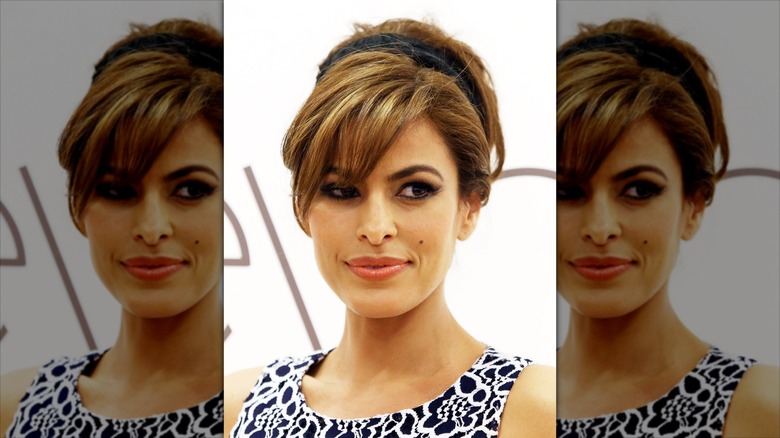 Eva Mendes posing at an event in a black and white dress