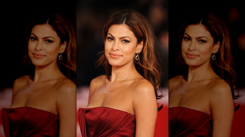 Eva Mendes posing on the red carpet in a strapless red dress