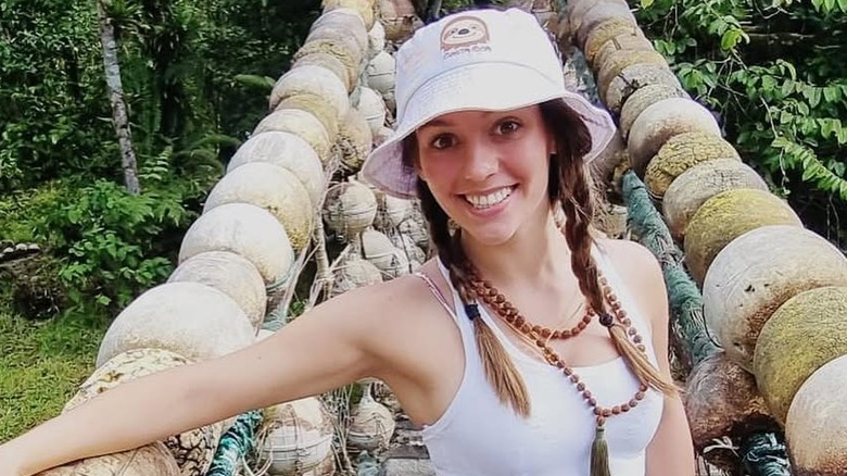 Jordon Hudson posing on a bridge without makeup