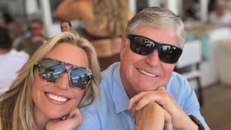 Ainsley Earhardt posing at a restaurant with Sean Hannity.