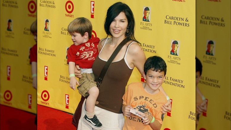 Lauren Sánchez Bezos posing on the red carpet with her sons Nikko and Evan