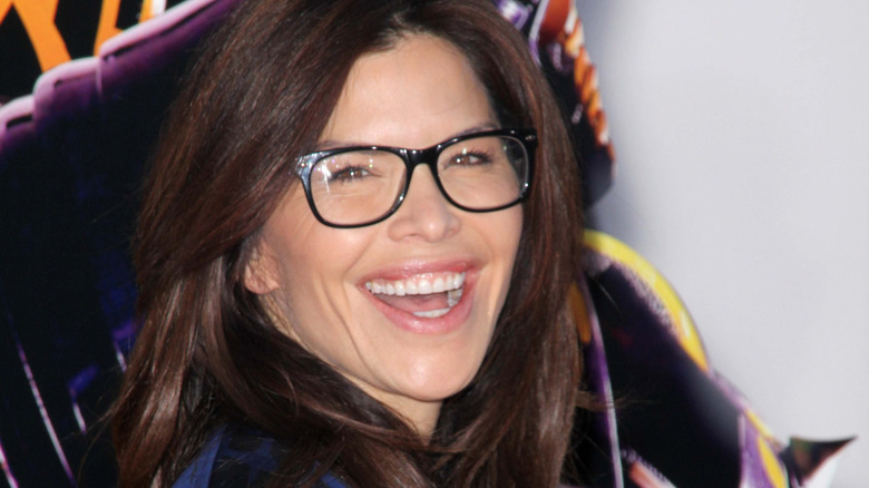 Lauren Sanchez wearing glasses and smiling on the red carpet