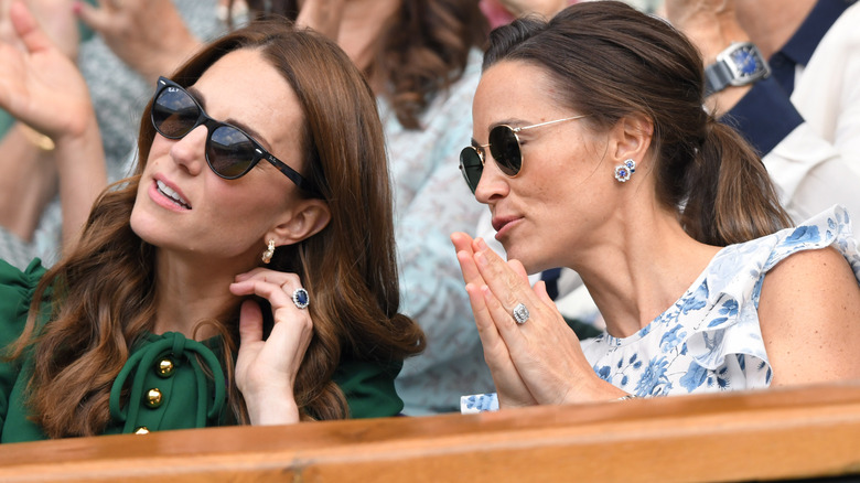 Kate Middleton and Pippa Middleton sitting in a crowd