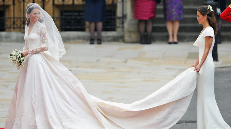 Pippa Middleton holds Kate Middleton's wedding dress train