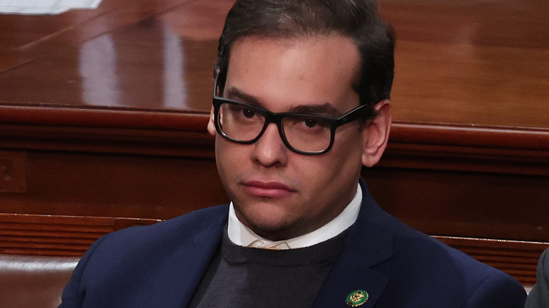 George Santos sitting and looking on