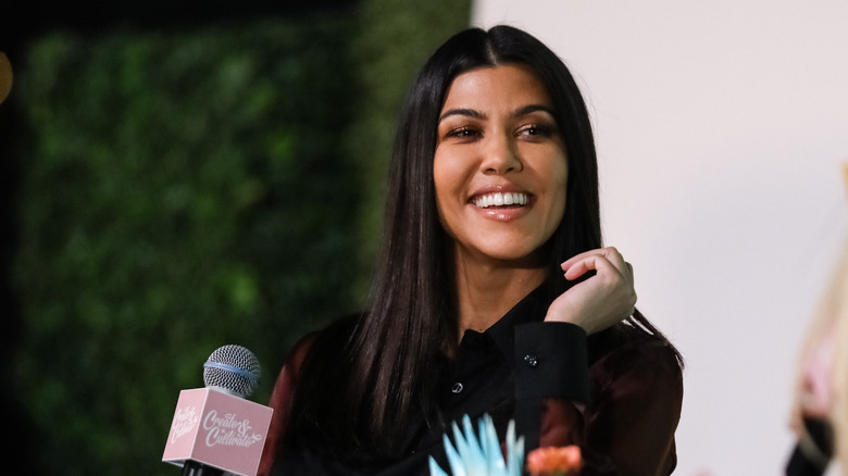 Kourtney Kardashian with microphone