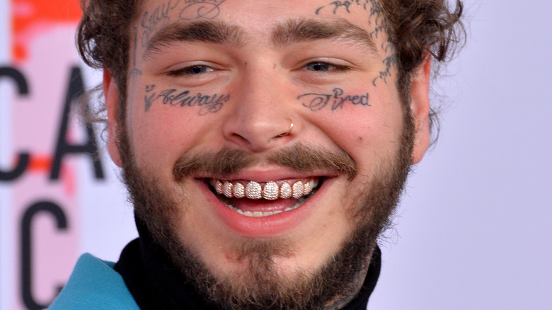 Post Malone singing with grills