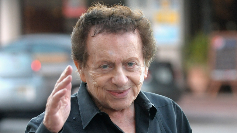Jackie Mason smiling and waving