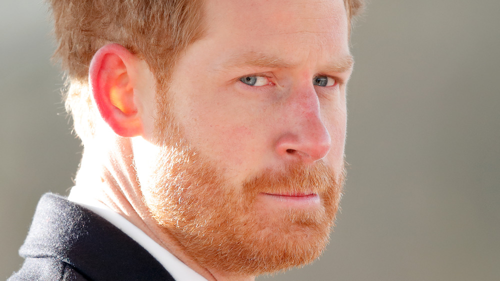 Prince Harry appears somber in a photo