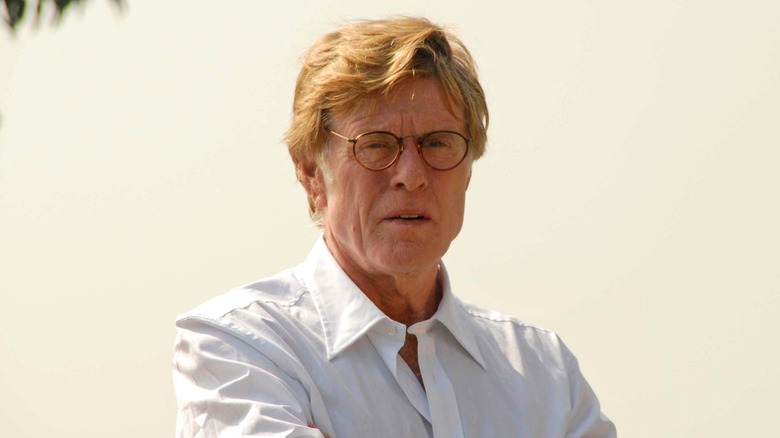 Robert Redford wearing glasses with serious expression