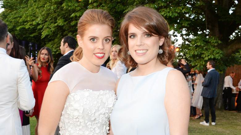 Princess Beatrice and Princess Eugenie outside posing