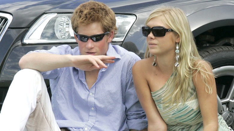 Prince Harry and Chelsy Davy sitting on grass