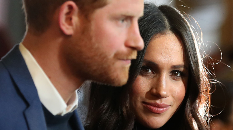 Meghan Markle and Prince Harry looking in different directions
