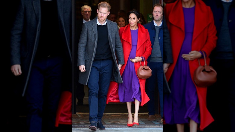 Prince Harry and a pregnant Meghan Markle holding hands while walking beside each other.
