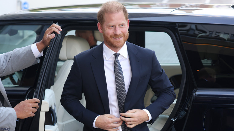 Prince Harry smiling as he leaves a car
