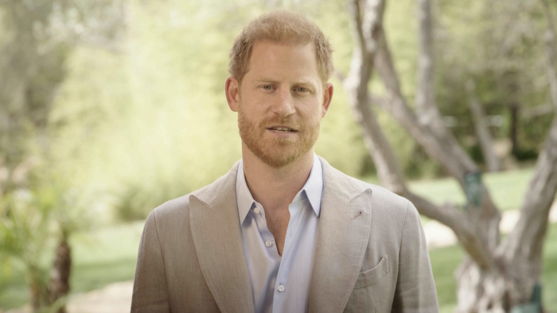 Prince Harry standing in front of trees