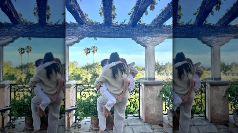 Meghan Markle holds Prince Archie and Princess Lilibet at their California home