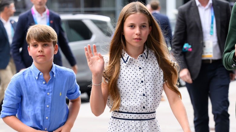 Prince Charlotte waving with Prince Louis walking behind her at the 2026 Commonwealth Games