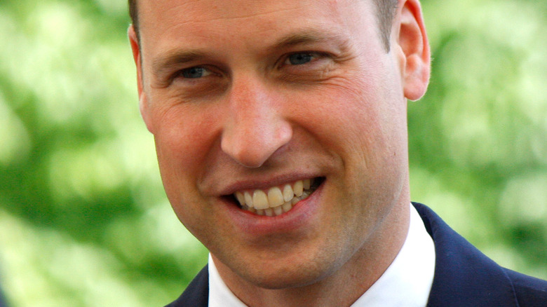 Prince William smiles at an engagement