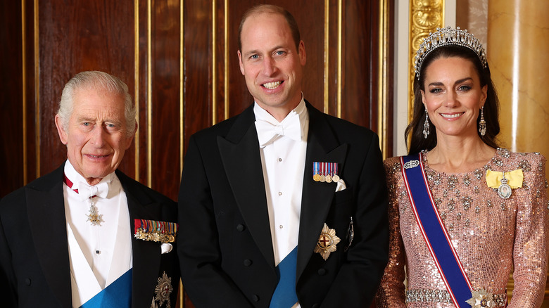 King Charles III, Prince William, and Princess Kate posing