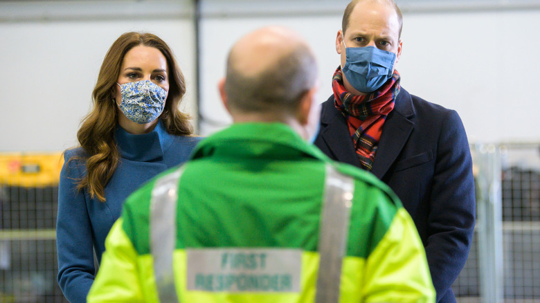 Kate Middleton and Prince William frowning behind face masks