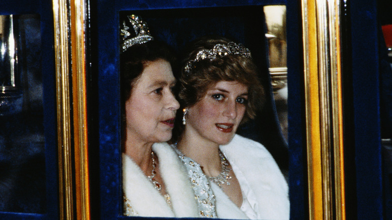 Queen Elizabeth II and Princess Diana sit together in a carriage in 1982