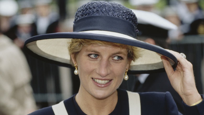 Princess Diana with a hat smiling