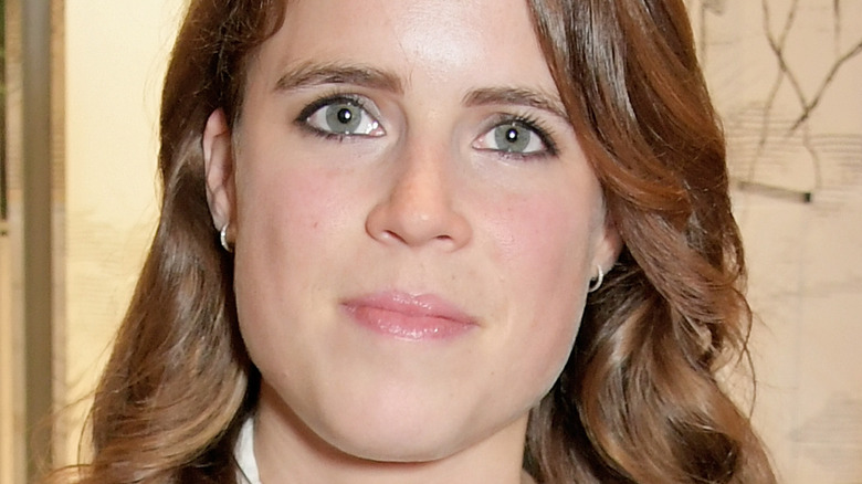 Princess Eugenie, not smiling, 2019 fashion event, reddish brown hair down, no hat