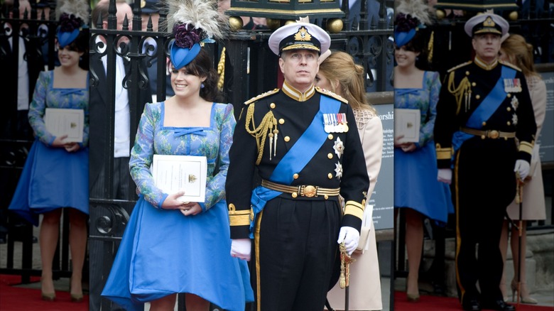 Princess Eugenie in a blue hat and dress standing next to Prince Andrew