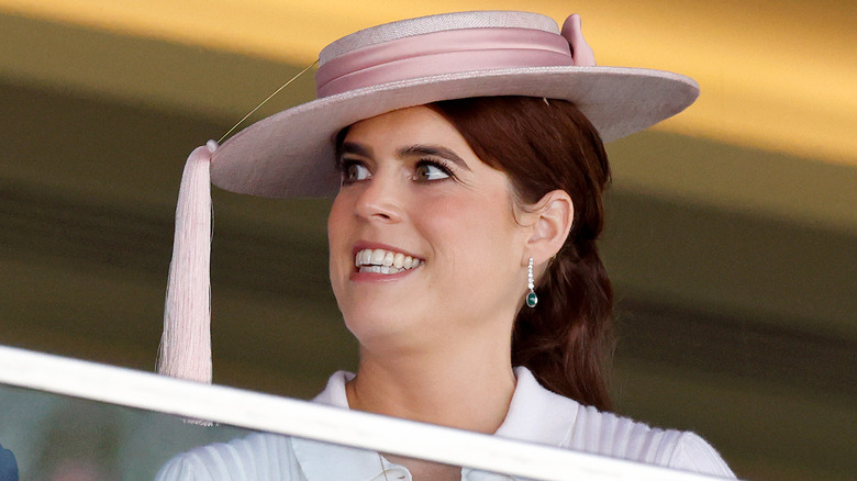 Princess Eugenie wearing a side tilted pink hat with long tassle
