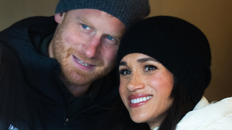 Prince Harry and Meghan Markle smiling with heads together