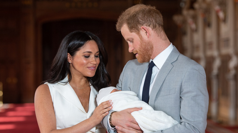 Meghan Markle and Prince Harry smiling at Prince Archie