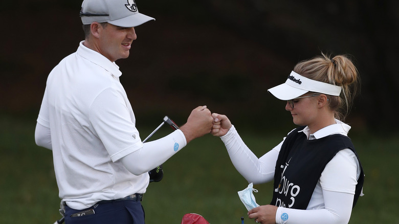 Aaron Cockerill fist-bumping his caddie