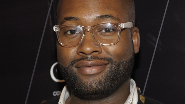 Mychael Knight smiling with clear glasses