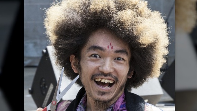 Kooan Kosuke posing with fabric scissors