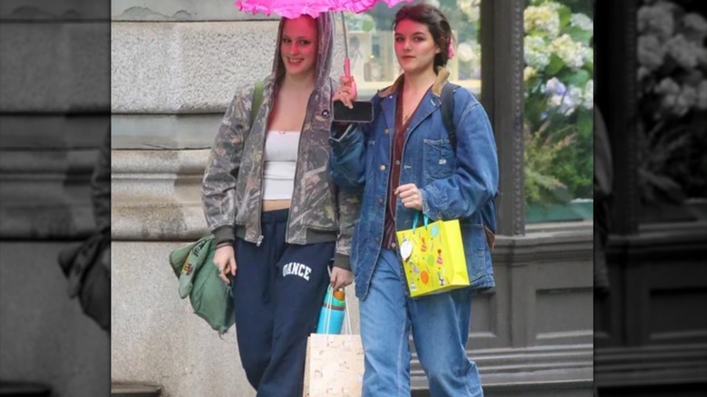 Suri Cruise walking with friend 