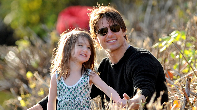 Suri Tom Cruise smiling field