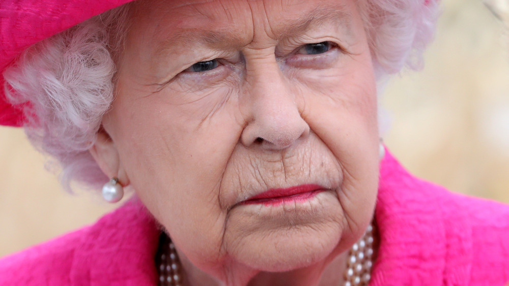 Queen Elizabeth II looking serious in hot pink