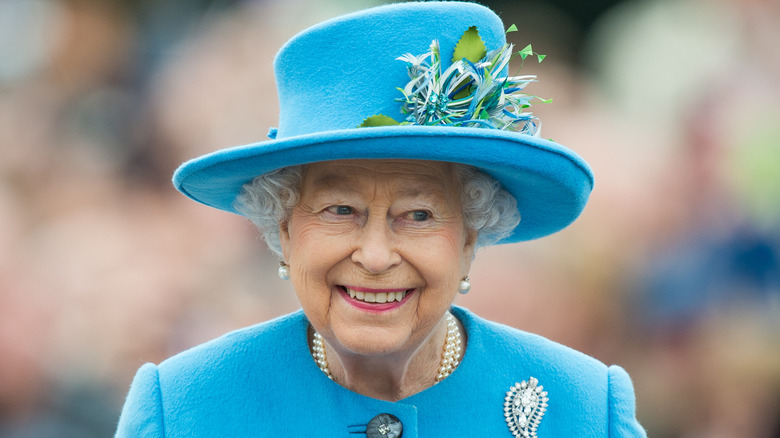 Queen Elizabeth wearing a blue hat