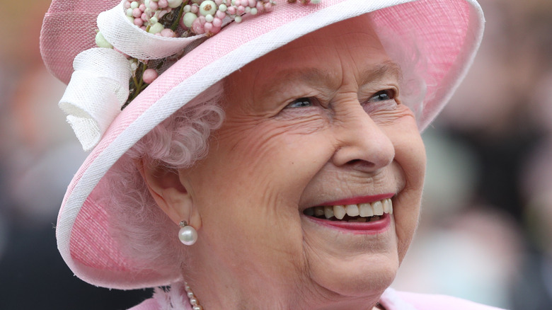 Queen Elizabeth smiling up in pink