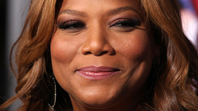 Queen Latifah with slight smile and wavy hair
