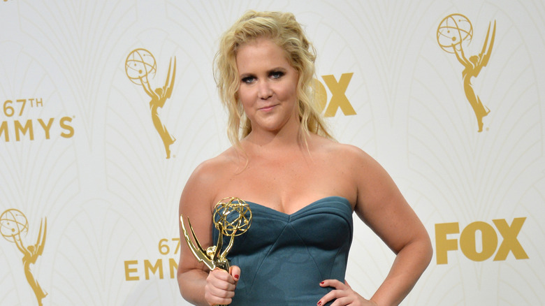 Amy Schumer holding an Emmy